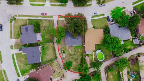 an aerial view of residential house with outdoor space and swimming pool