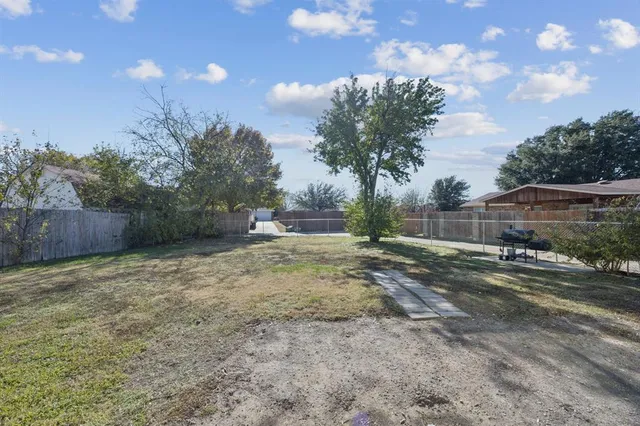 a view of a house with yard and a tree
