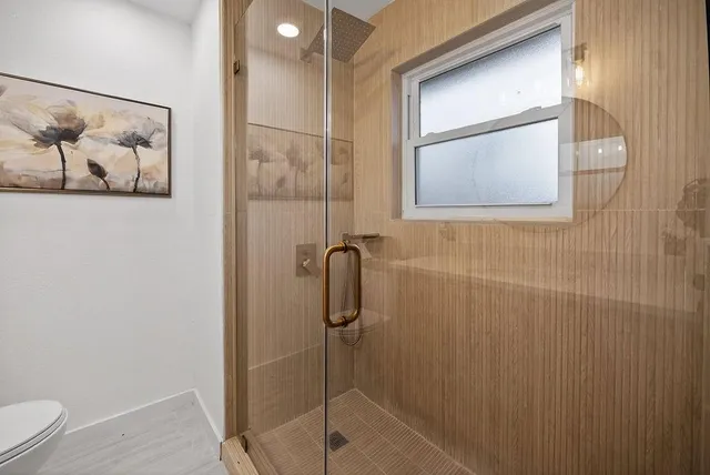 a bathroom with a shower and toilet