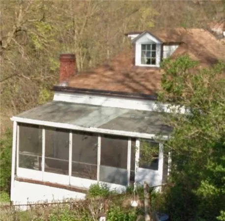a view of house with backyard