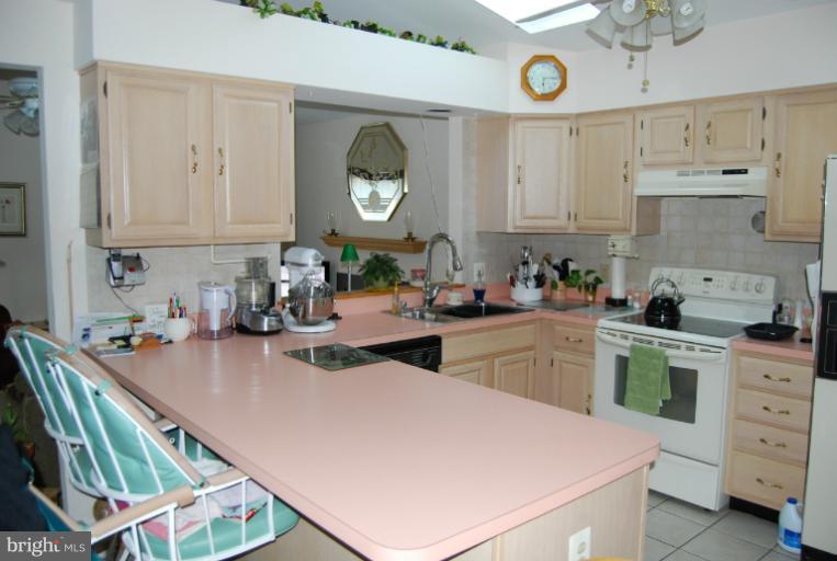4308 Spring Avenue Halethorpe, MD 21227 - Photo 2 of 21 a kitchen filled with a white stove top oven and cabinets