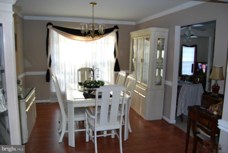 4308 Spring Avenue Halethorpe, MD 21227 - Photo 10 of 21 a view of a dining room with furniture window and wooden floor