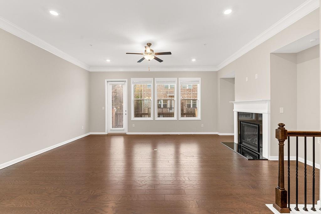 759 Topsail Lane Alpharetta, GA 30005 - Photo 14 of 50 an empty room with wooden floor fireplace and windows