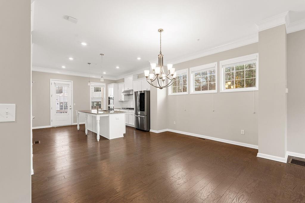 759 Topsail Lane Alpharetta, GA 30005 - Photo 15 of 50 a view of a kitchen with stove and wooden floor
