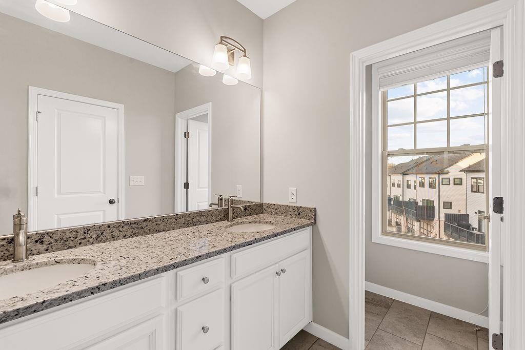 759 Topsail Lane Alpharetta, GA 30005 - Photo 33 of 50 a bathroom with a granite countertop sink and a mirror
