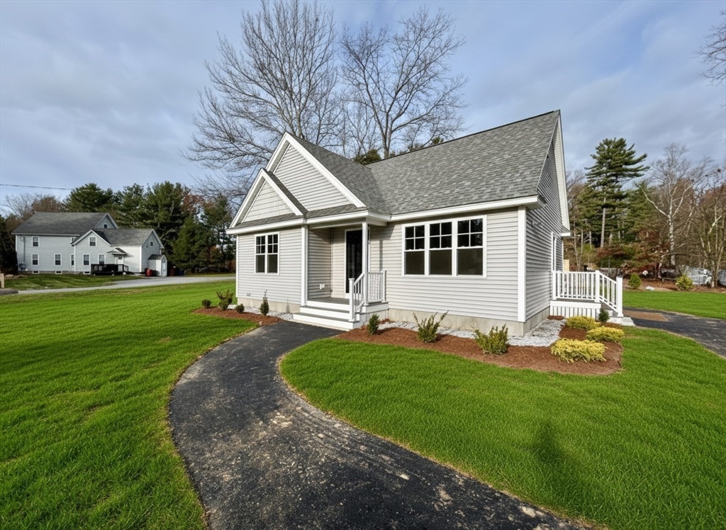 a front view of a house with garden