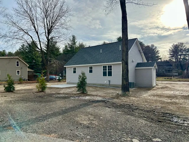 a view of a house with a yard covered in the road