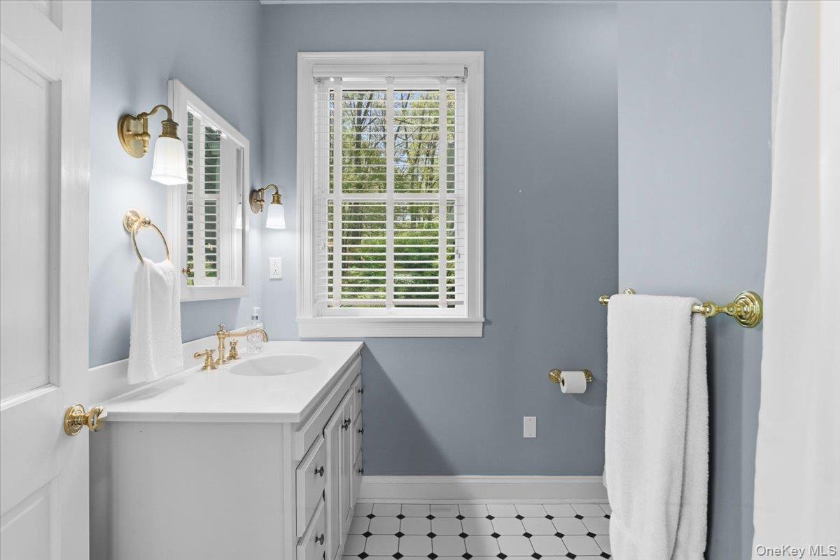 44 Scofield Road Pound Ridge, NY 10576 - Photo 16 of 36 a bathroom with a sink vanity and a mirror