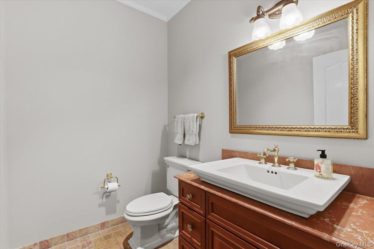 44 Scofield Road Pound Ridge, NY 10576 - Photo 17 of 36 a bathroom with a sink a toilet and mirror