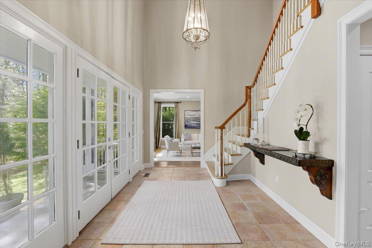 44 Scofield Road Pound Ridge, NY 10576 - Photo 2 of 36 a view of a hallway with wooden floor and staircase