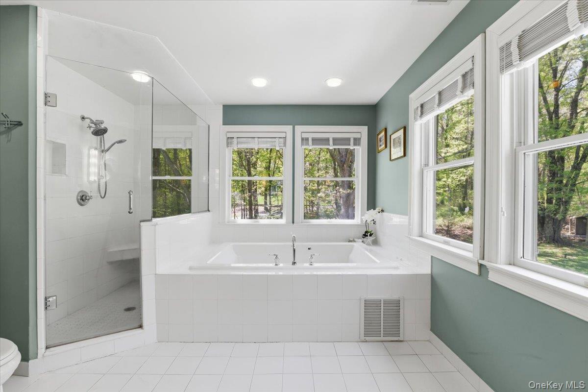 44 Scofield Road Pound Ridge, NY 10576 - Photo 21 of 36 a white bath tub sitting in a bathroom next to a window