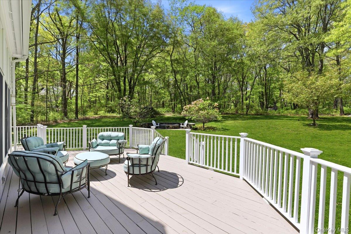 44 Scofield Road Pound Ridge, NY 10576 - Photo 28 of 36 a view of a deck with two chairs and a table with wooden floor
