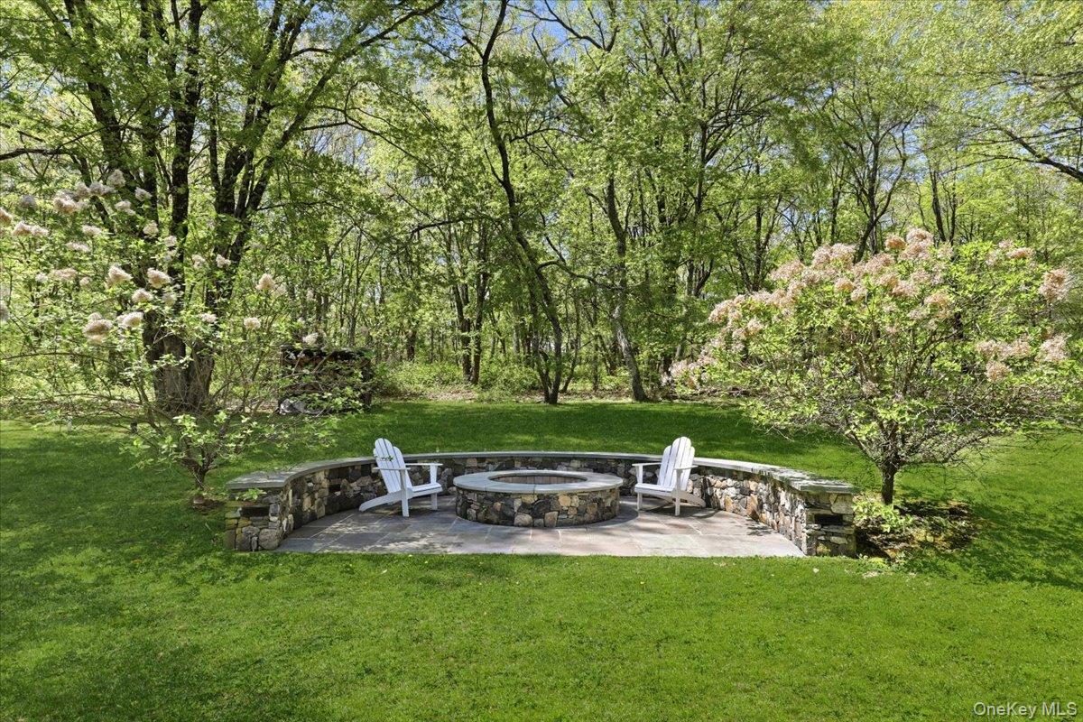 44 Scofield Road Pound Ridge, NY 10576 - Photo 29 of 36 a view of backyard with a garden and outdoor seating