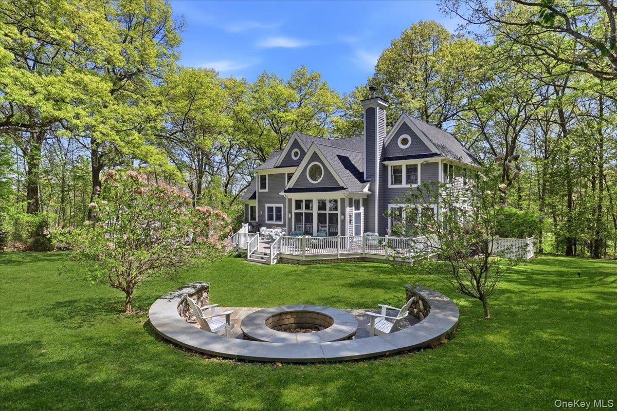 44 Scofield Road Pound Ridge, NY 10576 - Photo 30 of 36 a house with a big yard and potted plants in middle of the park