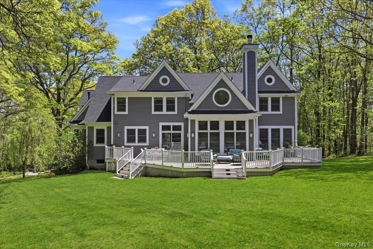 44 Scofield Road Pound Ridge, NY 10576 - Photo 31 of 36 a front view of a house with garden and trees