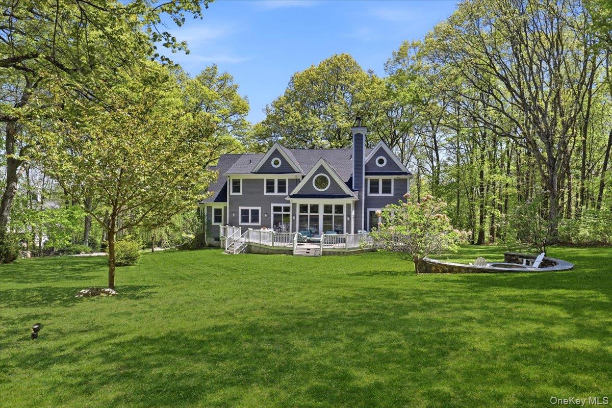 44 Scofield Road Pound Ridge, NY 10576 - Photo 33 of 36 a view of a house with a big yard and large trees