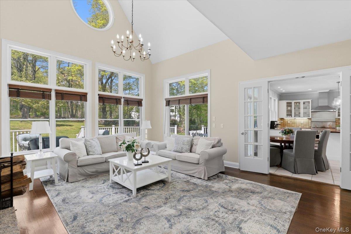 44 Scofield Road Pound Ridge, NY 10576 - Photo 7 of 36 a living room with furniture and a chandelier