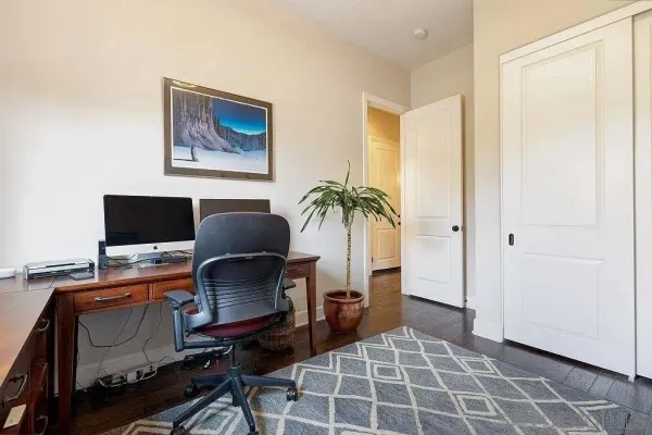a workspace with furniture and a gate