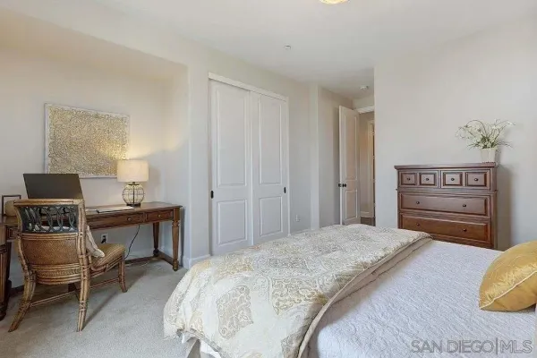 a bedroom with a bed and a table in it