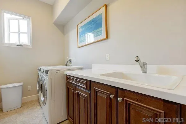 a utility room with a sink a washer and dryer