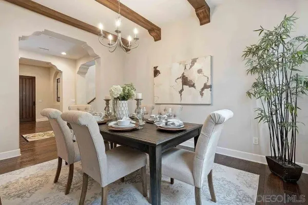 a view of a dining room with furniture and a chandelier