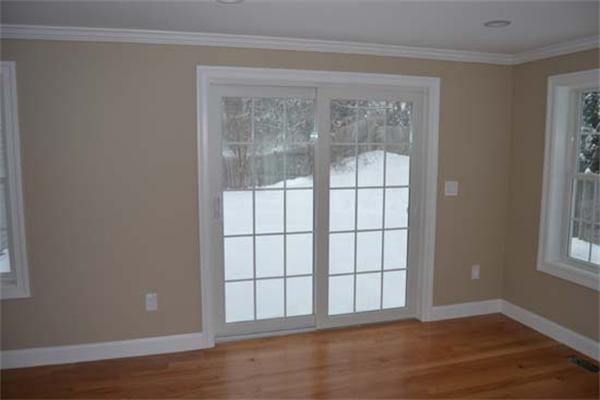 1 Henderson Avenue Andover, MA 01810 - Photo 12 of 26 a view of an empty room with wooden floor and a window