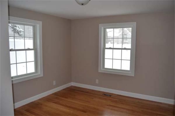 1 Henderson Avenue Andover, MA 01810 - Photo 13 of 26 an empty room with wooden floor and windows