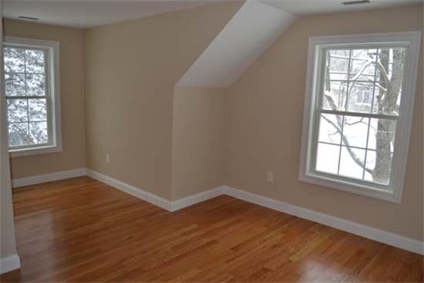 1 Henderson Avenue Andover, MA 01810 - Photo 14 of 26 an empty room with wooden floor and windows