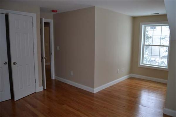 1 Henderson Avenue Andover, MA 01810 - Photo 15 of 26 an empty room with wooden floor and windows