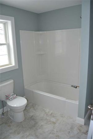 1 Henderson Avenue Andover, MA 01810 - Photo 17 of 26 a white toilet sitting next to a bath tub