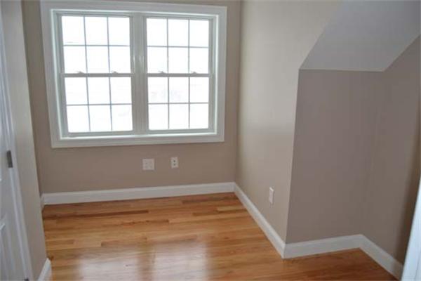 1 Henderson Avenue Andover, MA 01810 - Photo 19 of 26 an empty room with wooden floor and windows