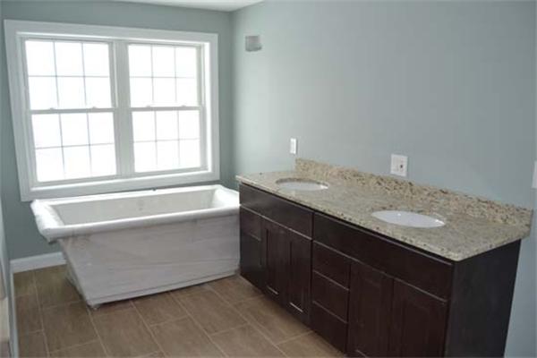 1 Henderson Avenue Andover, MA 01810 - Photo 21 of 26 a bathroom with a granite countertop bathtub sink and mirror