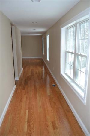 1 Henderson Avenue Andover, MA 01810 - Photo 22 of 26 a view of an empty room with wooden floor and a window