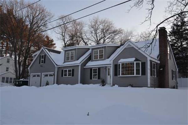 1 Henderson Avenue Andover, MA 01810 - Photo 25 of 26 a front view of a house with a yard covered in snow