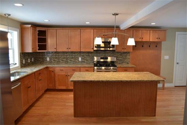 1 Henderson Avenue Andover, MA 01810 - Photo 4 of 26 a kitchen with kitchen island granite countertop a sink a counter top space and cabinets