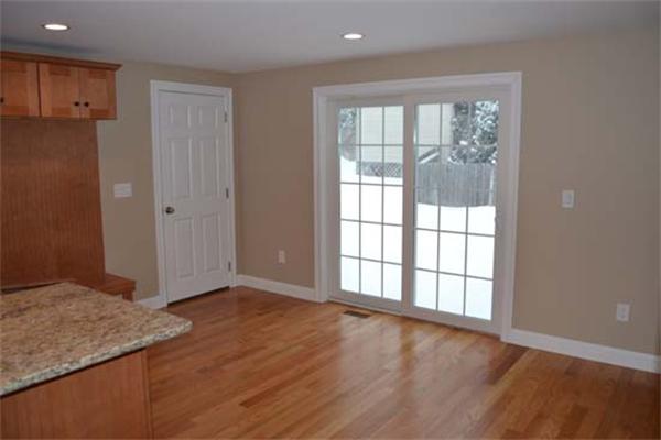 1 Henderson Avenue Andover, MA 01810 - Photo 5 of 26 an empty room with wooden floor and windows