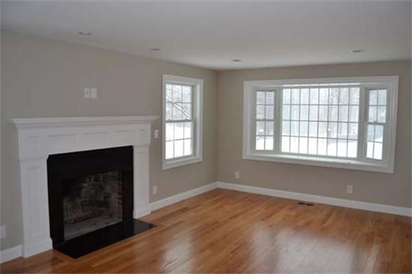1 Henderson Avenue Andover, MA 01810 - Photo 8 of 26 a living room with a fireplace and wooden floor