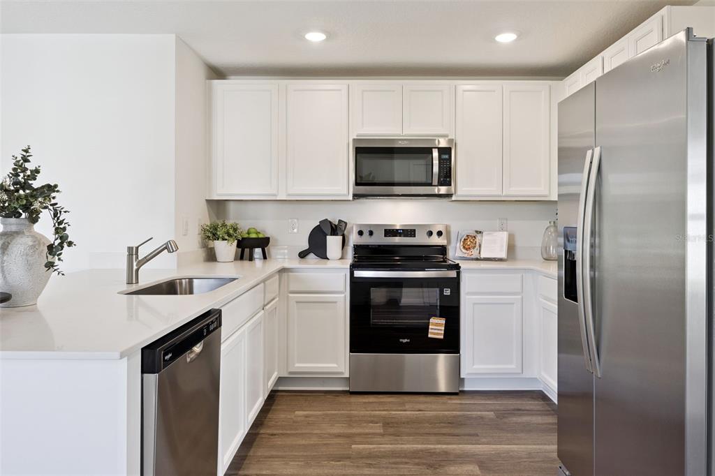 3419 Nettle Loop Tavares, FL 32778 - Photo 13 of 29 a kitchen with a refrigerator sink and microwave