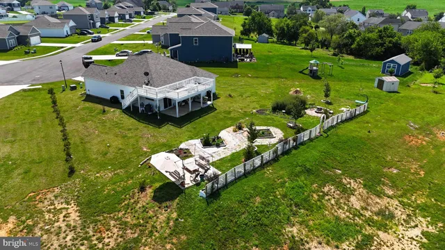 an aerial view of a house with garden space and street view
