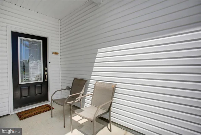 a hallway with seating space and wooden floor