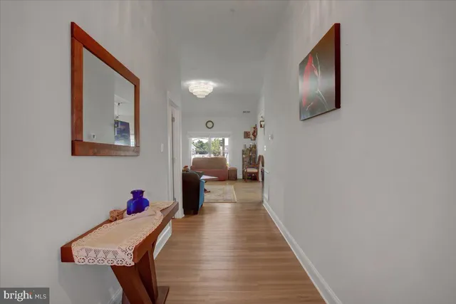 a view of a hallway with wooden floor and workspace