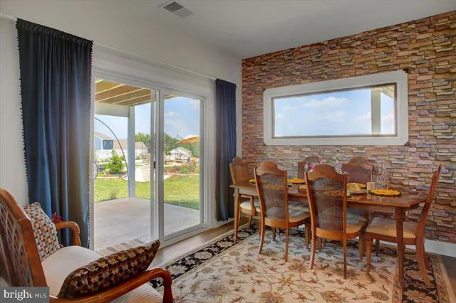 a kitchen with stainless steel appliances kitchen island granite countertop a refrigerator and a stove top oven