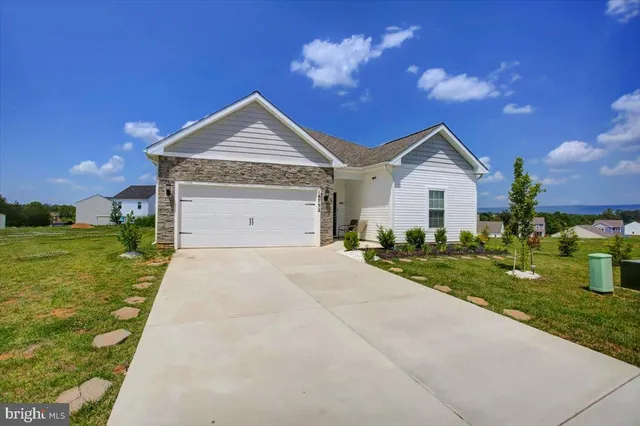 a view of a house with a yard and garage