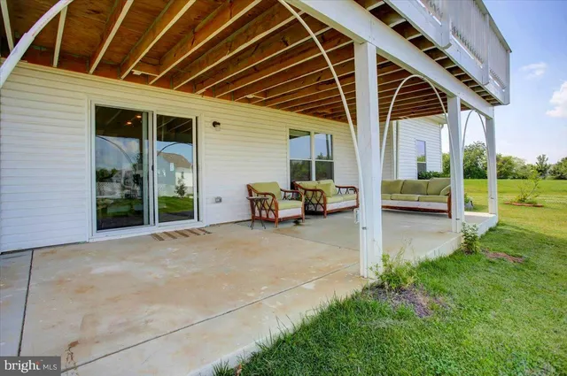 a view of a patio with table and chairs