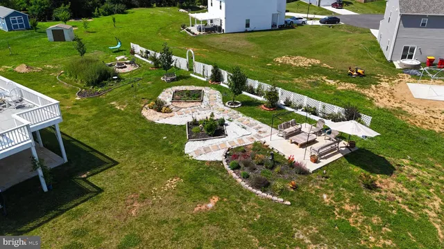 an aerial view of a house with yard swimming pool and outdoor seating