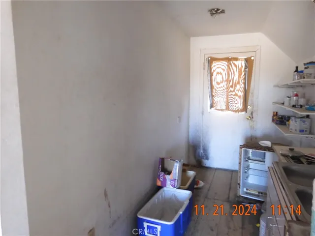 a room with wooden floor and a window