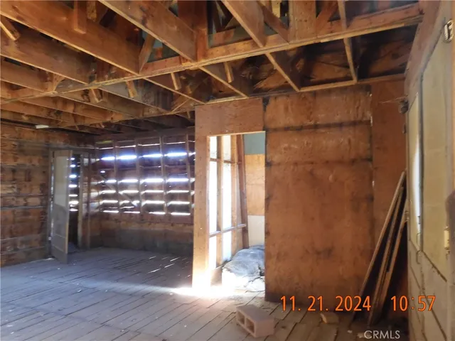 a view of a room with wooden floor