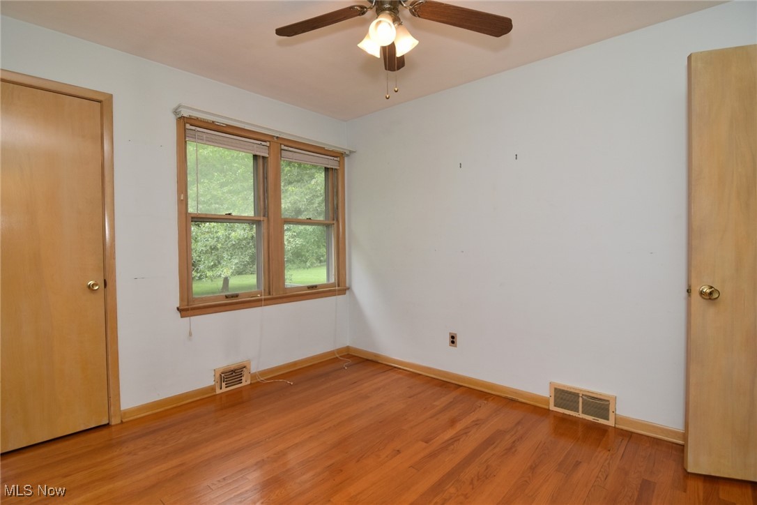 9421 David Road Cleveland, OH 44125 - Photo 19 of 36 Unfurnished bedroom with light wood-type flooring and a ceiling fan