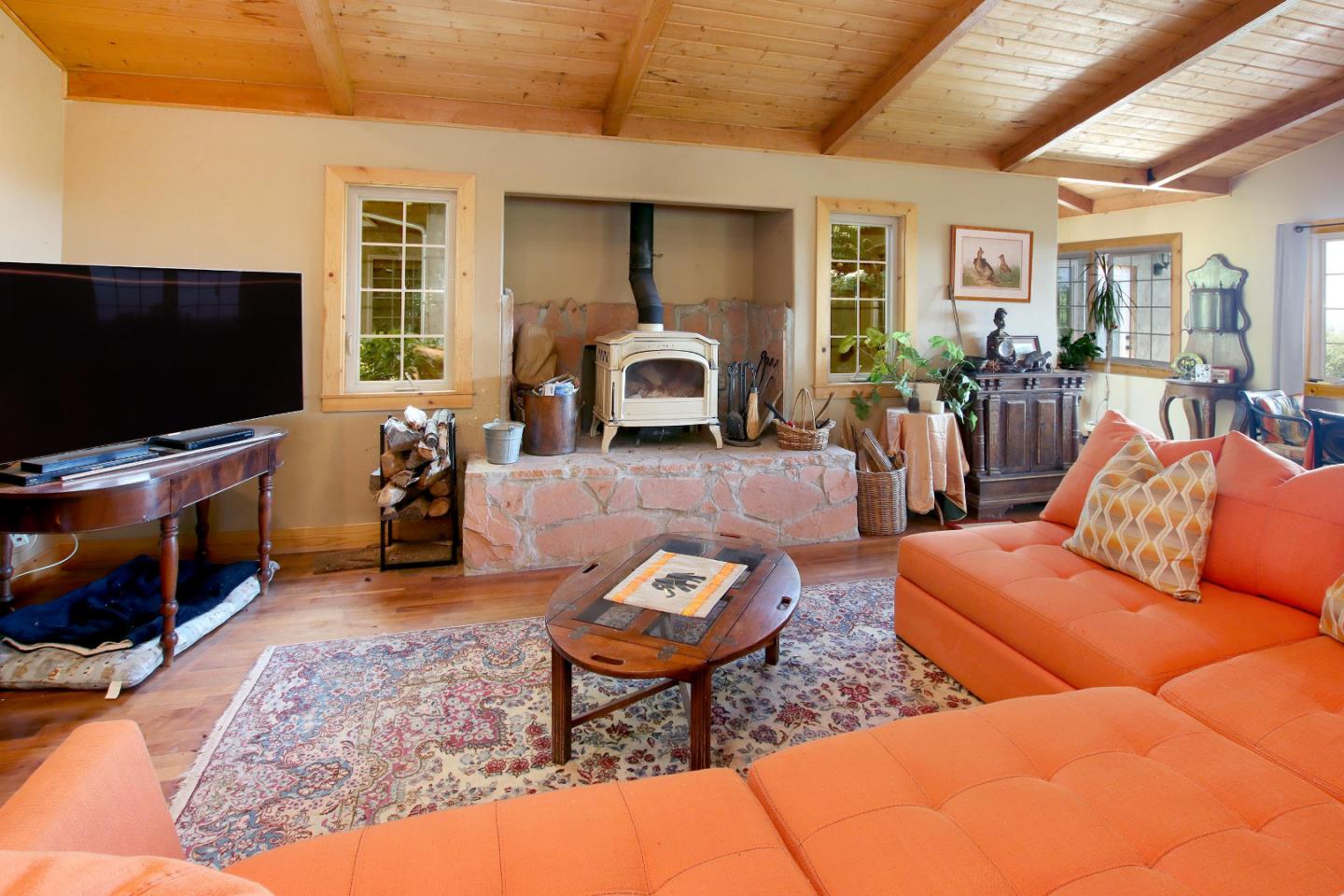 434 Old Smith Road Watsonville, CA 95076 - Photo 15 of 61 a living room with furniture a flat screen tv and a floor to ceiling window