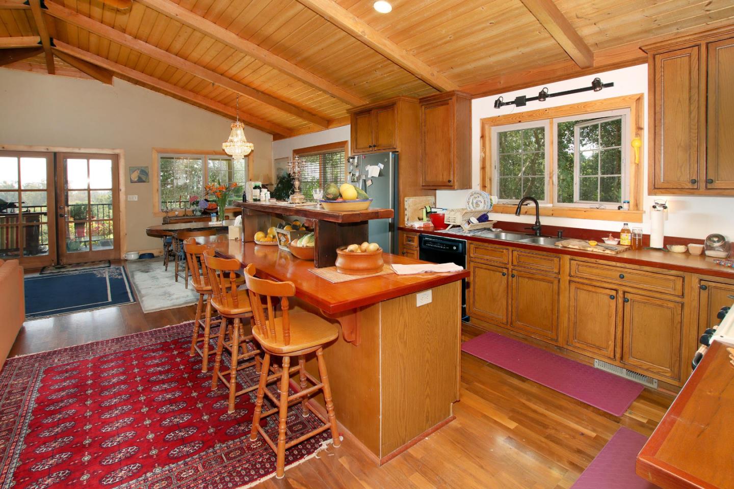 434 Old Smith Road Watsonville, CA 95076 - Photo 17 of 61 a dining hall with stainless steel appliances granite countertop a stove a sink dishwasher and cabinets with wooden floor